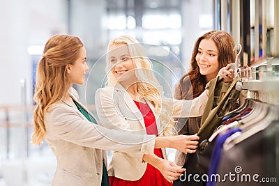 Happy young women choosing clothes in mall Stock Photo