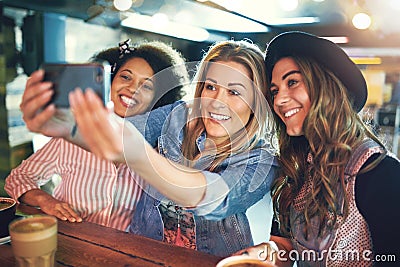 Happy young women friends posing for a selfie Stock Photo