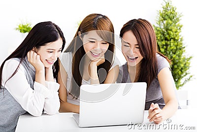 happy young women watching laptop in living room Stock Photo