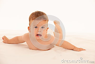 Hapy baby boy in playing on bed isolated over white Stock Photo