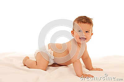 Hapy baby boy in playing on bed isolated over white Stock Photo