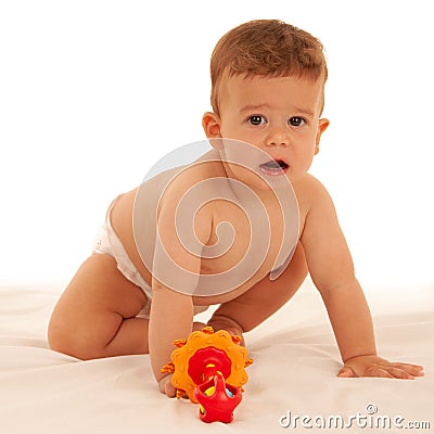 Hapy baby boy in playing on bed isolated over white Stock Photo