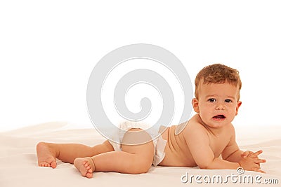 Hapy baby boy in playing on bed isolated over white Stock Photo