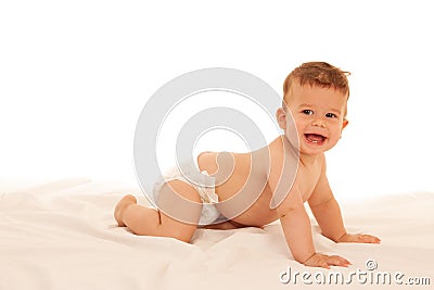 Hapy baby boy in playing on bed isolated over white Stock Photo