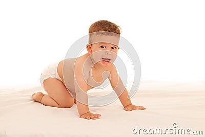 Hapy baby boy in playing on bed isolated over white Stock Photo