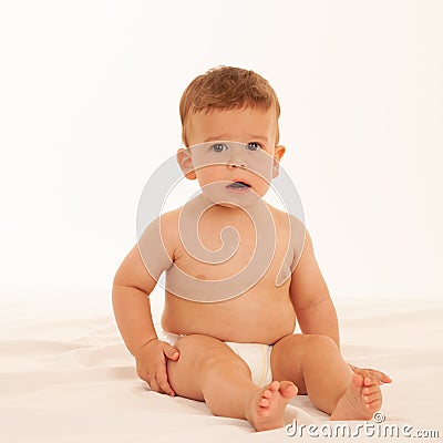 Hapy baby boy in playing on bed isolated over white Stock Photo