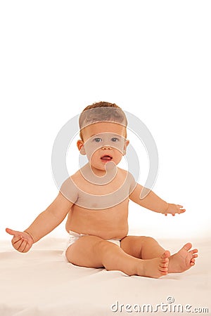 Hapy baby boy in playing on bed isolated over white Stock Photo