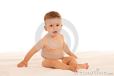 Hapy baby boy in playing on bed isolated over white Stock Photo