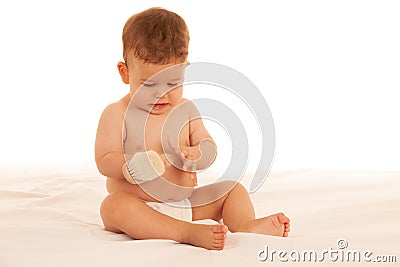 Hapy baby boy in playing on bed isolated over white Stock Photo