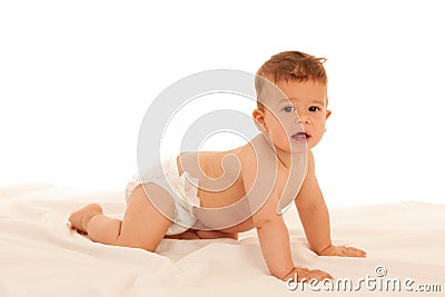 Hapy baby boy in playing on bed over white Stock Photo