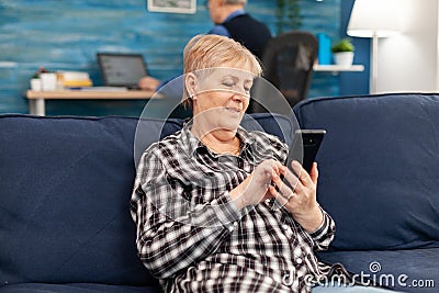 Hapy elderly lady texting on phone Stock Photo