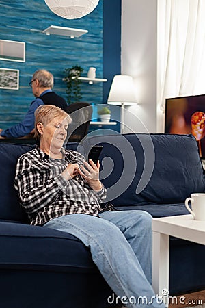 Hapy elderly lady texting on phone Stock Photo