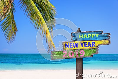 Hapy new year 2019 on a colored wood direction signs, beach and palm tree background Stock Photo