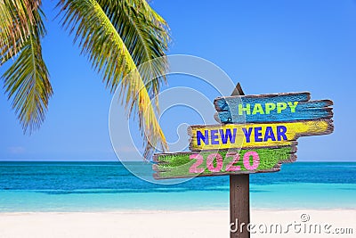 Hapy new year 2020 on a colored wooden direction signs beach and palm tree background Stock Photo