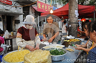 Hawkers and peddlers selling food and grocery in walking street Editorial Stock Photo