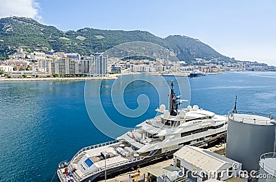 Harbor and the Bay of Gibraltar with a densely populated town area and a luxury yacht Alfa Nero Editorial Stock Photo