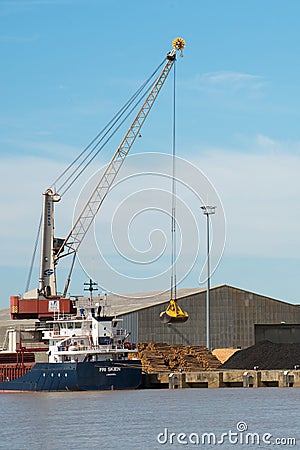 Harbor crane loading a ship with wood. Bordeaux port Editorial Stock Photo