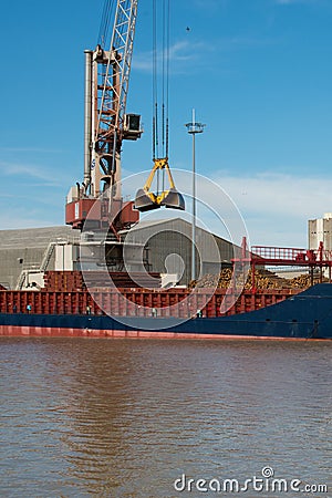 Harbor crane loading a ship with wood. Bordeaux port Editorial Stock Photo