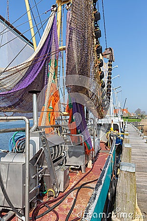 Harbor dutch fishing village Makkum with shrimp trawler drying nets Editorial Stock Photo