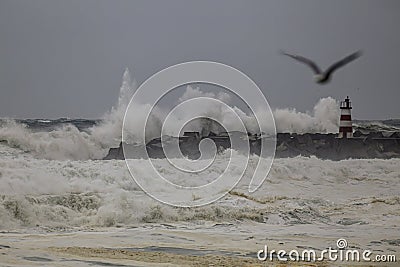 Harbor entry pier and beacon during sea storm Stock Photo