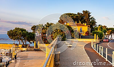Harbor and exclusive residential peninsula along Plage del la Salis beach onshore Mediterranean Sea in Antibes in France Editorial Stock Photo