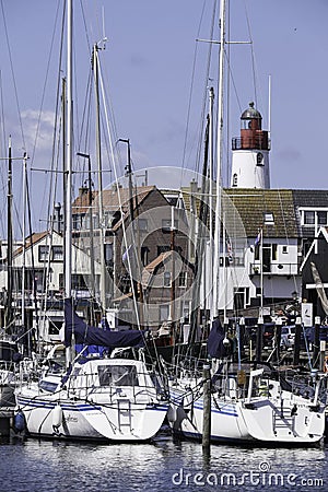 Small fishing town Urk west harbour with fishing and sailing boats and lighthouse Editorial Stock Photo