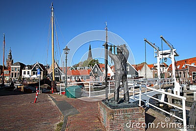 The harbor with the Statue of De Visroker The Fish Smoker, sculptor Cerneus, unveiled in 1994 in the foreground Editorial Stock Photo