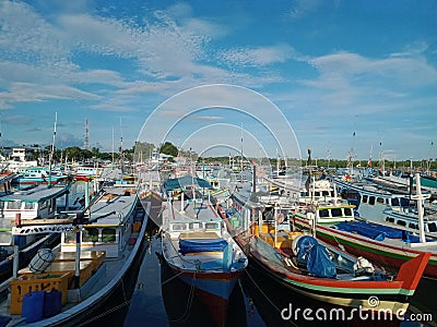 Harbored Serenity: A picturesque view of a fleet of boats gracefully anchored in tranquil waters& x22; Editorial Stock Photo