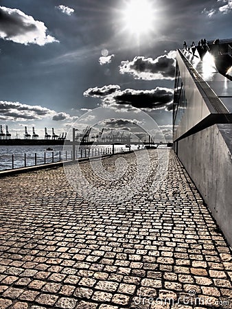 Harbour area in the Hamburg along the river with cranes Stock Photo