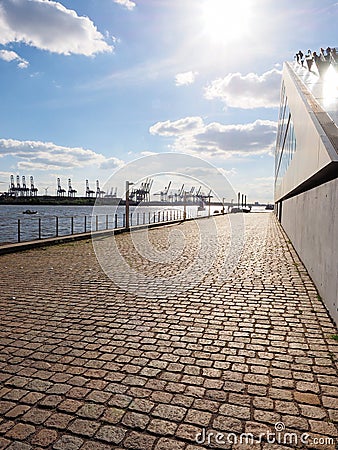 Harbour area in the Hamburg along the river with cranes and buildings Stock Photo