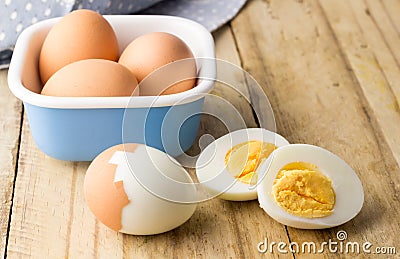 Hard boiled chicken eggs on rustic wooden table Stock Photo