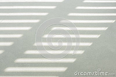 Hard, diagonal floor shadows on gray tiles from window shutters or blinds. Attractive abstract half frame composition Stock Photo