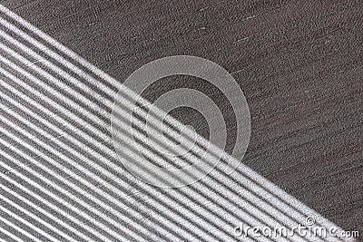 Hard diagonal shadows on grey textured wall from a window roller shutter or blinds. Attractive abstract half frame composition Stock Photo