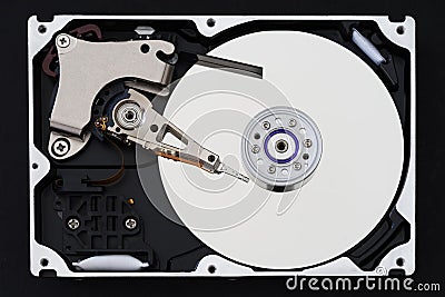 Hard disk drive with removed cover, hdd inside flat view, spindle, actuator arm, read write head, platter, ribbon cable Stock Photo