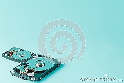 Hard disk drives opened on a blue background Stock Photo