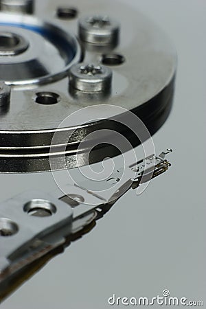 Hard-drive read-write sensor and reflective disk surface Stock Photo