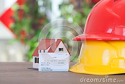 Hard hat on behalf of migrant workers, small house on behalf of hometown and a return train ticket.The Chinese characters on the t Stock Photo