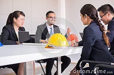 Hard hats safety helmet in meeting room,Blured of people architect and engineer at office Stock Photo