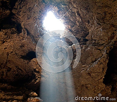 The hard light through hole in the cave Stock Photo