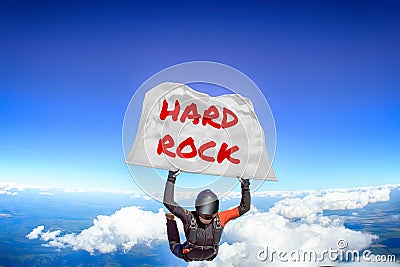 Hard Rock. Flag in skydiving. People in free fall.Teampleat skydiver. Extreme sport. Stock Photo