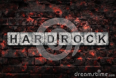 Hard Rock. Words on stone block alphabet, on old vintage bricks wall. Direction in music. Musical style. Design Stock Photo