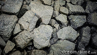 Hard and rough rocks at the beach Stock Photo