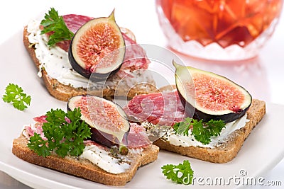 Hard salami with figs canapes Stock Photo