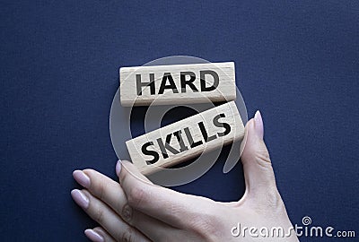 Hard skills symbol. Wooden blocks with words Hard skills. Beautiful deep blue background. Businessman hand. Business and Hard Stock Photo