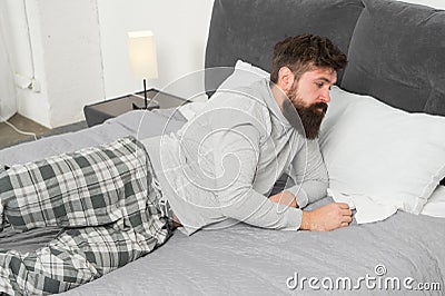 Hard to wake up. bearded man hipster want to sleep in morning. brutal sleepy man in bedroom. mature male with beard in Stock Photo