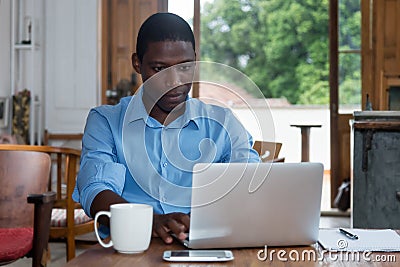 Hard working african american man with laptop Stock Photo