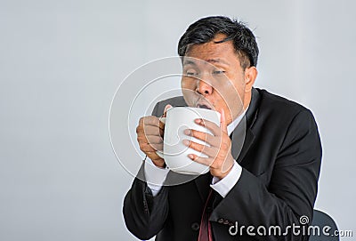 Hard working businessman Fatigue Drinking coffee /Isolate Stock Photo