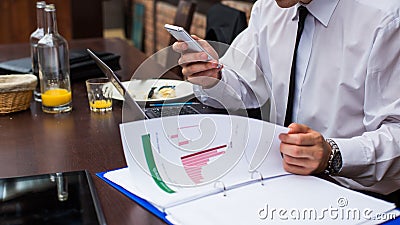 Hard working businessman in restaurant. Stock Photo