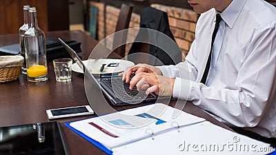 Hard working businessman in restaurant. Stock Photo