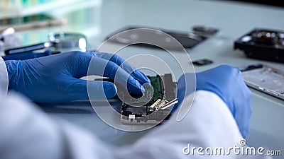 Hardware specialist analyzing computer part, forensic science experiment, it Stock Photo